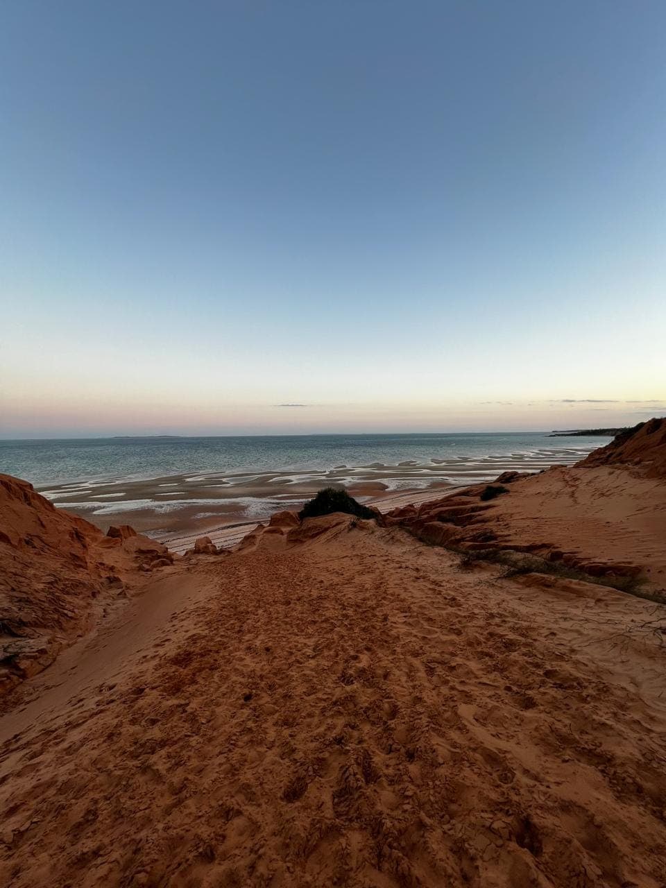 Path over the famous red dunes down to the sea