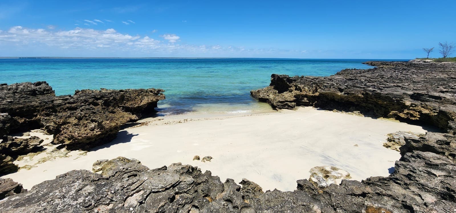 Secluded rocky cove with white sand