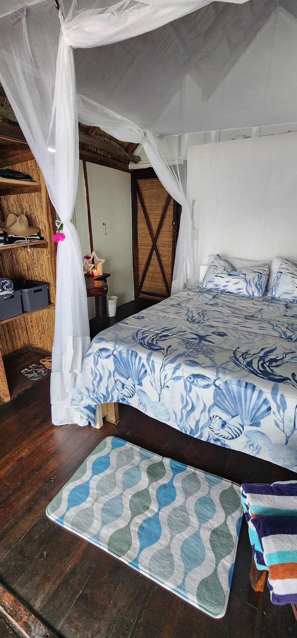 Bedroom with canopy net and coastal linen