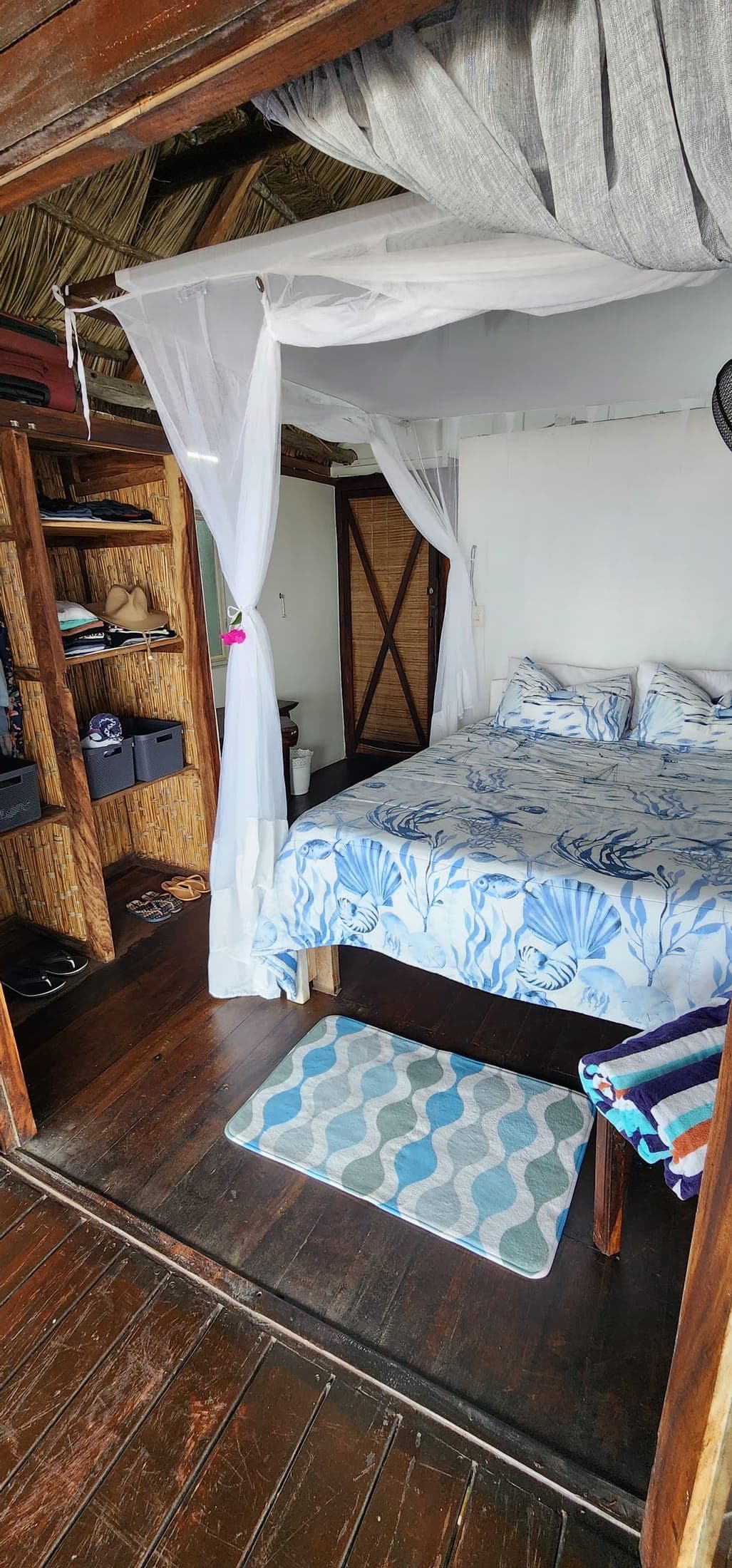 Main bedroom with four-poster bed and mosquito net