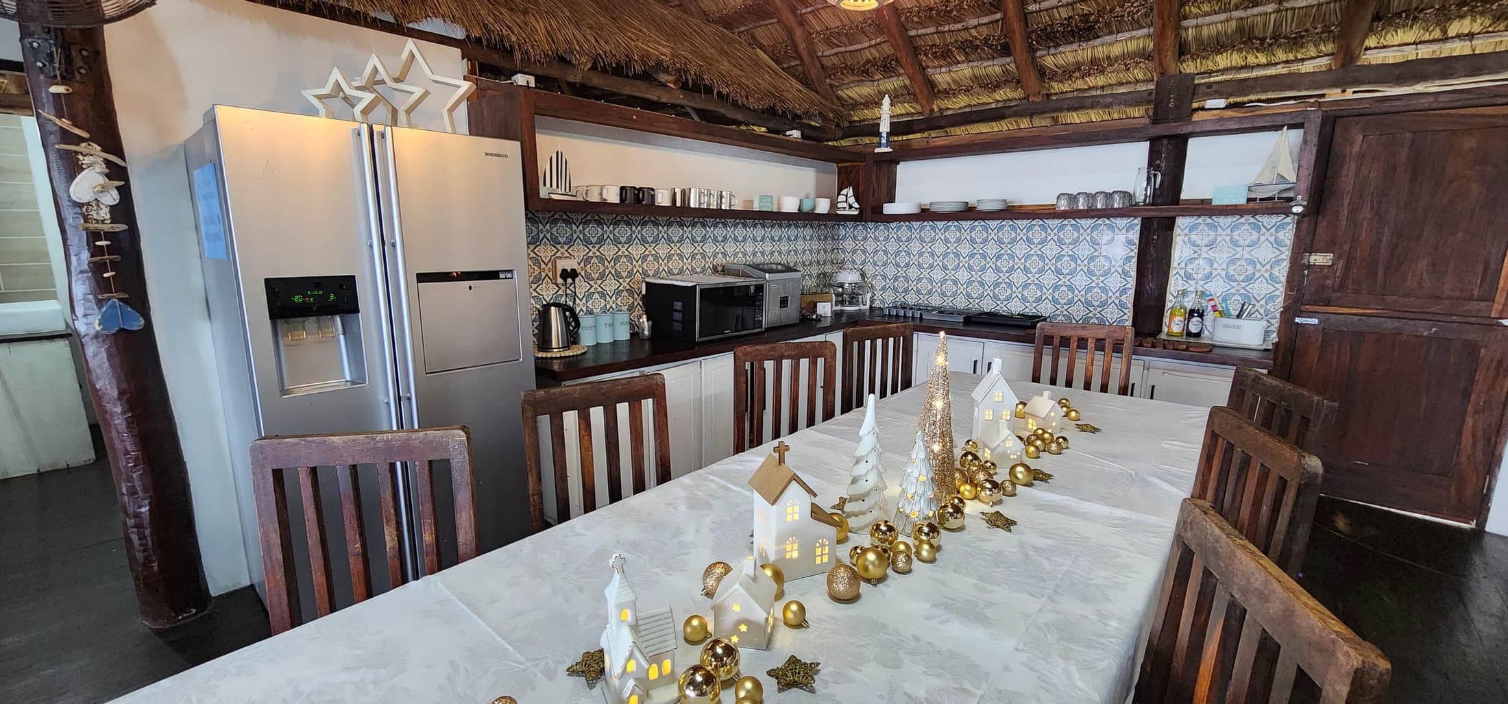 Kitchen with gas stove, fridge-freezer and ocean-tile splashback