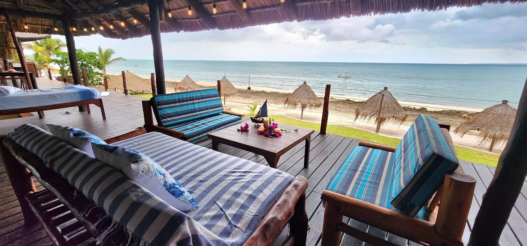 Covered deck with loungers overlooking the beach